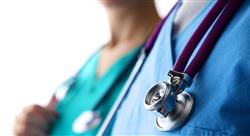 young doctor standing with a stethoscope on a white background